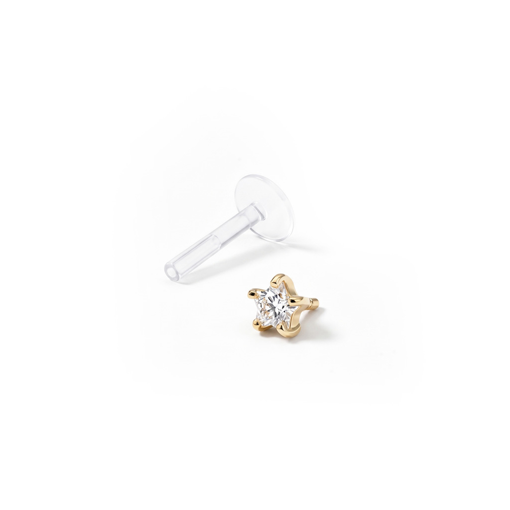 Labret uit 14 karaats goud met een stervormige steen en ptfe staaf